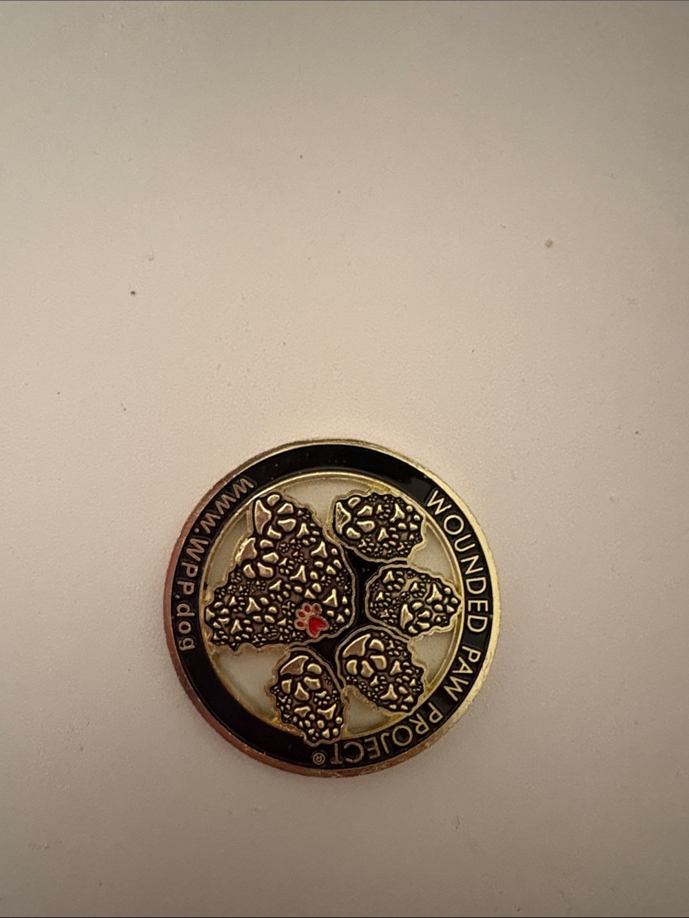 Wounded Paw Project Gold and Black Paw Token